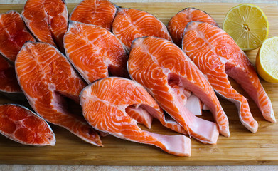 Red fish steak, freshly cut with peel on a cutting board