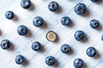 Being different concept. Going against the grain or moving upstream. Minimal. Healthy food concept. Summer fruit. Blueberry pattern flat lay. Copy space. Creative layout. Isometric