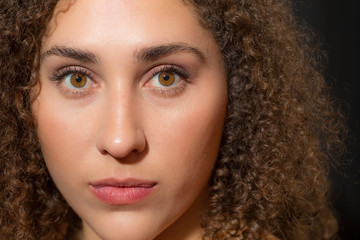 Young latin lady in a extreme closeup picture with a natural and fresh face of twenty something woman.