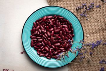 Dry red beans in the plate on the table