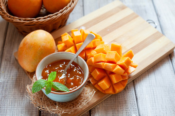 Homemade mango jam on wooden background