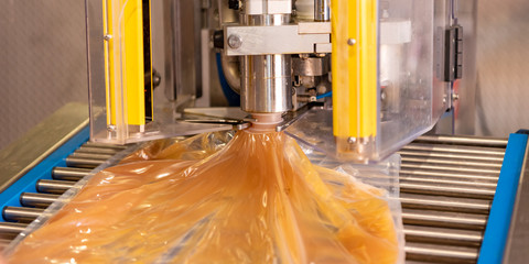  Apple direct juice after pressing. Bottling on a machine in bag in box