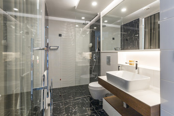 Interior of a luxury hotel bathroom with glass shower cabin