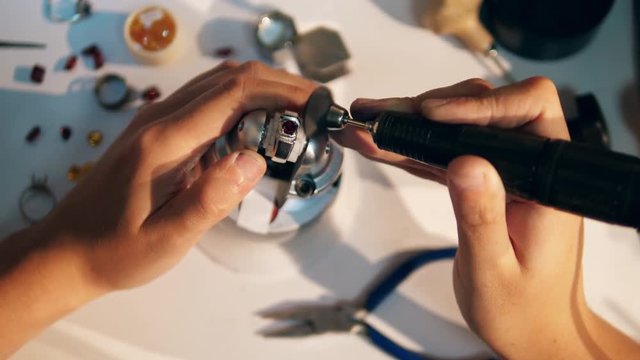 Polishing process of a ring with a precious stone. Jeweler Working jewelry