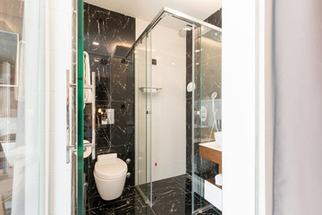 Interior of a luxury hotel bathroom with glass shower cabin