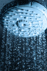 Falling water drops from shower head.