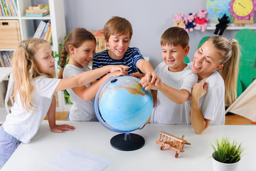 Teacher with School Children Making Geography Lessons Fun and Interesting. Learning Through Play.