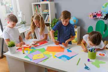 Creative projects with children at home or at school. Kids making some paper crafts. 