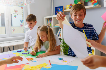 Creative projects with children at home or at school. Kids making some paper crafts. 