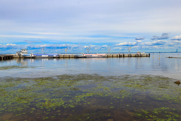 Fototapeta premium Hydrofoil boats moored at the open coast of Gulf of Finland, in Peterhof (suburb of St. Petersburg), Russia