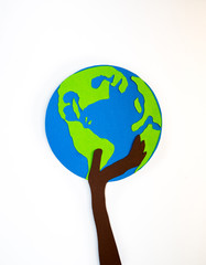 Human's hand carefully holding the globe. Lets save our planet, environmental concept. Paper cut design background.