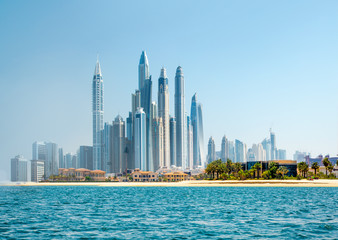 Fototapeta na wymiar Dubai, UAE United Arabs Emirates. Panoramic view of Dubai skyscrapers at the coast. Skyscrapers and Persian gulf. 