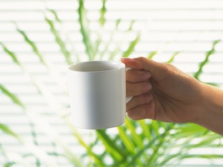 hand holding cup of coffee
