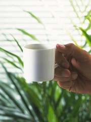 hand holding a cup of coffee