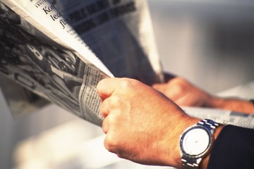 businessman holding newspaper