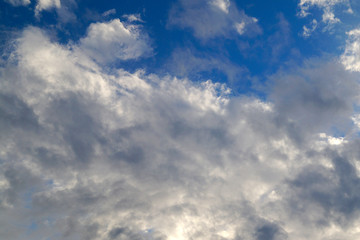 Large white cumulus clouds on a blue sky for background or ecology or nature.
