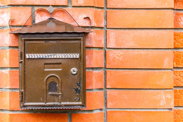 A beautiful mailbox hangs waiting for newspapers, parcels and letters.