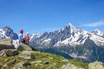Young mother and her newborn daughter relaxing in mountains