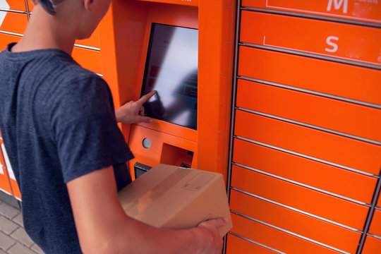 Client using automated self service post terminal machine or locker to deposit a parcel for storage
