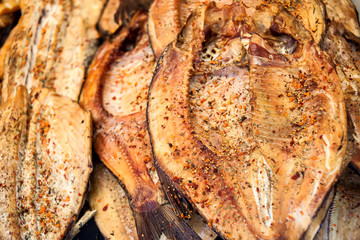 Fresh smoked fish in the market close up shot.