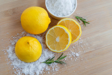 Lemon and sea salt - Beauty treatment with organic cosmetics with lemon ingredients on wood and...