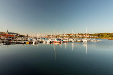Fototapeta na wymiar Sailboats moored in harbor against clear sky