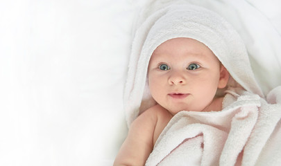cute happy little baby in white towel