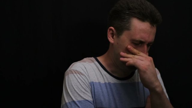 unhappy young handsome caucasian man shows his emotion close-up