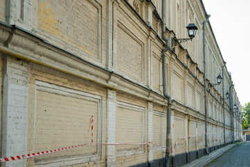 Fototapeta na wymiar Long brick wall of an old building