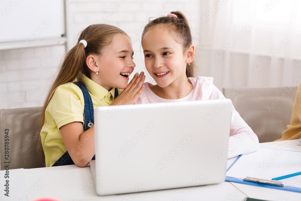 Poster Classmates whispering and using laptop after lesson