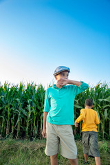 Harvesting. Children walk across the field with corns