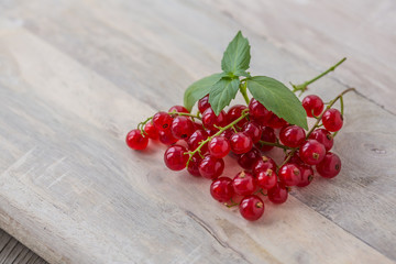 Fresh red currant on wooden background. Close up photo of the fresh berries. Harvest Concept