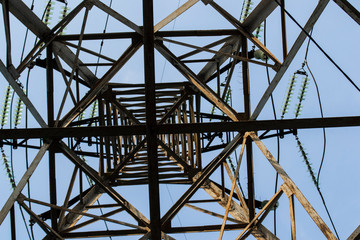 high-voltage metal tower against the sky