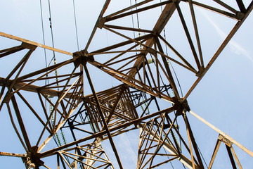 High-voltage metal tower against the sky