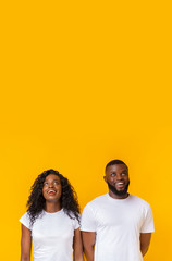 Amazed african american man and woman looking upwards