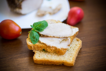 sandwich with home baked meat in a plate on a wooden