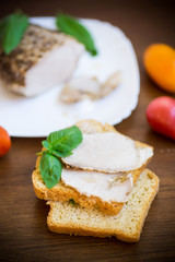 sandwich with home baked meat in a plate on a wooden