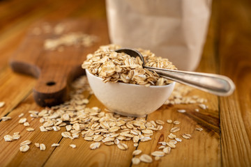 Tasty oatmeal on a wooden kitchen table. Healthy food used for slimming diets for obese people.