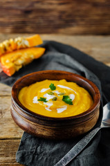 Pumpkin soup with pumpkin seeds and parsley leaves