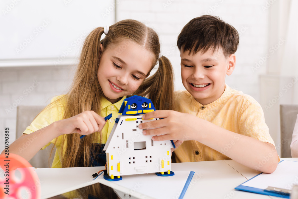 Aufkleber happy kids constructing robotic toy at stem class