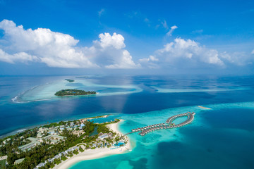Aerial view of beautiful island at Maldives in the Indian Ocean. Top view from drone. - obrazy, fototapety, plakaty