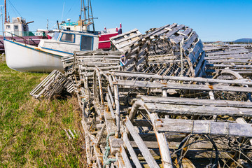 Old wooden lobster traps and fishing boats in Newfoundland, Canada