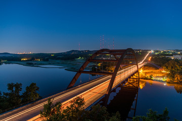 Night View of the Austin 360 Bridge With Austin Downtown Skyline in the horizon