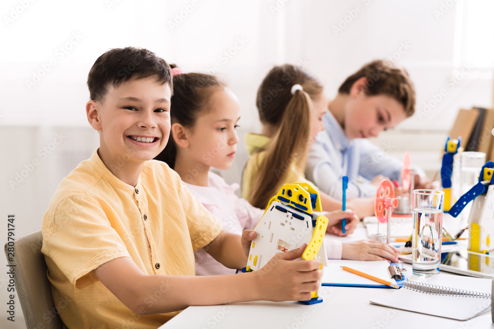 Poster Stem education. Boy creating robot at lab