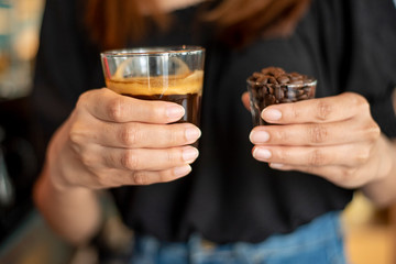 Black coffee in small shot .