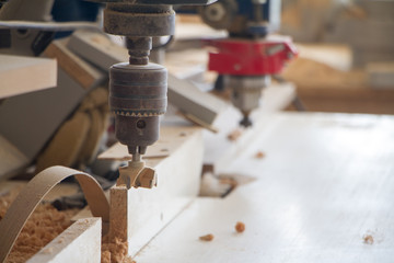 Boring machine with nozzle in the furniture workshop, selective focus