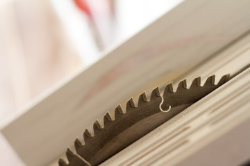 Close-up of teeth and disk surface of a circular saw, selective focus