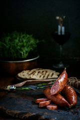 Bavarian smoked sausages from pork cut on a wooden Board. Rustic style