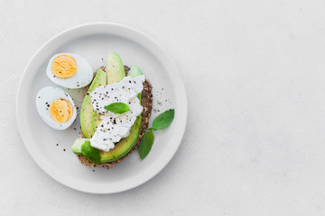 Homemade Avocado Toast with Salt, Pepper, Feta and Egg. Healthy breakfast,