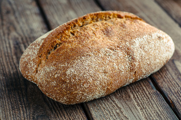 loaf of bread on wooden background, food closeup.Fresh homemade bread.French bread. Bread at leaven. Unleavened bread.Ciabatta bread.